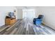Comfortable living room features wood flooring, access to outside, and an inviting recliner at 1535 Nursery Rd # 107, Clearwater, FL 33756