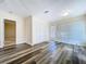 Bright living room featuring wood-look flooring, closet space, and access to outdoor living at 1535 Nursery Rd # 107, Clearwater, FL 33756