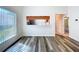 The dining room has wood-look floors, a pass-through, and bright natural light from the window at 1535 Nursery Rd # 107, Clearwater, FL 33756