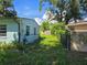 Backyard with plants and an alleyway between houses at 1607 Stevensons Dr, Clearwater, FL 33755