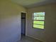 Bedroom with window and view of grass at 1607 Stevensons Dr, Clearwater, FL 33755