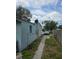 Side view of a single-story house with a walkway, featuring neutral siding and a well-defined roofline at 1607 Stevensons Dr, Clearwater, FL 33755