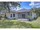 Lush backyard with screened-in patio at 16501 Sandhill Crane Dr, Spring Hill, FL 34610