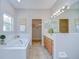 Bathroom with a large tub, double sinks, and walk-in closets at 16501 Sandhill Crane Dr, Spring Hill, FL 34610