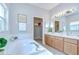 Bright bathroom featuring a soaking tub, double vanity, and a linen closet at 16501 Sandhill Crane Dr, Spring Hill, FL 34610