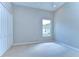 Bright bedroom features a large window, neutral carpet, and a closet with bi-fold doors at 16501 Sandhill Crane Dr, Spring Hill, FL 34610