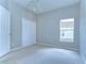 Bright bedroom features plush carpet, window and closet at 16501 Sandhill Crane Dr, Spring Hill, FL 34610