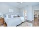 Comfortable bedroom with hardwood floors, neutral tones, and connecting bathroom at 16501 Sandhill Crane Dr, Spring Hill, FL 34610
