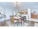 Dining area showcasing wood floors, seamlessly transitioning into the kitchen with bar seating at 16501 Sandhill Crane Dr, Spring Hill, FL 34610