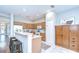Bright kitchen featuring wood cabinets, a breakfast bar with seating, and modern appliances at 16501 Sandhill Crane Dr, Spring Hill, FL 34610