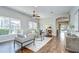 Bright living room with hardwood floors, neutral furniture, and seamless access to other living areas at 16501 Sandhill Crane Dr, Spring Hill, FL 34610