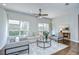 Bright living room featuring neutral furniture, hardwood floors, and a ceiling fan at 16501 Sandhill Crane Dr, Spring Hill, FL 34610