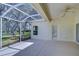Screened lanai offers outdoor living space with views of the surrounding greenery and mature trees at 16501 Sandhill Crane Dr, Spring Hill, FL 34610