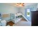 bedroom with hardwood floors, bunk beds with a slide, and a ceiling fan at 17712 Long Ridge Rd, Tampa, FL 33647