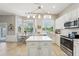 Bright kitchen featuring an island, pendant lighting, stainless steel appliances, and an adjacent dining area at 17712 Long Ridge Rd, Tampa, FL 33647