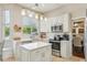 Bright kitchen featuring white cabinetry, stainless steel appliances, and a center island with a breakfast bar at 17712 Long Ridge Rd, Tampa, FL 33647