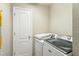 Well-lit laundry area featuring a new Maytag washer and dryer at 17712 Long Ridge Rd, Tampa, FL 33647