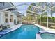 Beautiful screened-in pool with spa, lounge chairs, and inviting patio area at 17712 Long Ridge Rd, Tampa, FL 33647