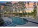 Enjoy the beautiful screened-in pool and spa, perfect for relaxation and entertaining at 17712 Long Ridge Rd, Tampa, FL 33647