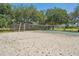 A sandy volleyball court next to a basketball area in the community park with ample room at 17712 Long Ridge Rd, Tampa, FL 33647