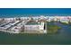 Aerial view of condos with boat docks, showcasing a vibrant coastal community with beach access and waterfront amenities at 19451 Gulf Blvd # 506, Indian Shores, FL 33785