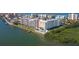 Picturesque waterfront condo featuring a pool, dock, and beautifully landscaped grounds, offering a serene coastal living experience at 19451 Gulf Blvd # 506, Indian Shores, FL 33785