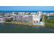 Waterfront condo with boat docks and community pool, set against the backdrop of the ocean and neighboring buildings at 19451 Gulf Blvd # 506, Indian Shores, FL 33785