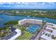 Aerial view of Bay Shores Yacht & Tennis Club, showing complex, tennis courts, and waterfront at 19451 Gulf Blvd # 506, Indian Shores, FL 33785