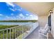 Cozy balcony overlooking a serene waterfront view, furnished with comfortable seating for relaxation at 19451 Gulf Blvd # 506, Indian Shores, FL 33785