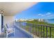 Balcony with seating and views of the water and harbor at 19451 Gulf Blvd # 506, Indian Shores, FL 33785