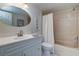 Bathroom featuring a single vanity, shower and tub combination, and large mirror at 19451 Gulf Blvd # 506, Indian Shores, FL 33785