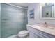 Bathroom with a marble countertop vanity, a walk-in shower with glass door, and neutral paint at 19451 Gulf Blvd # 506, Indian Shores, FL 33785