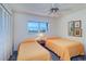 Bright bedroom with two twin beds, closet, and a window with an ocean view at 19451 Gulf Blvd # 506, Indian Shores, FL 33785