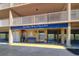 Bay Shores Yacht & Tennis Club entrance with blue awning, elevator, and coastal landscaping at 19451 Gulf Blvd # 506, Indian Shores, FL 33785