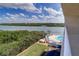Aerial view of a community pool overlooking the water, complete with lounge chairs and a hot tub at 19451 Gulf Blvd # 506, Indian Shores, FL 33785