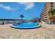 Community pool with ample seating areas and a beautiful view from the adjacent sun deck at 19451 Gulf Blvd # 506, Indian Shores, FL 33785