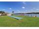 Shuffleboard court and dock situated on a well-manicured green lawn with water views at 19451 Gulf Blvd # 506, Indian Shores, FL 33785