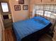 Bedroom with metal bed frame, built-in cabinets, and a door to the outside at 2043 Ketch Cir, Palm Harbor, FL 34683