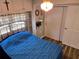 Bedroom with metal bed frame, built-in cabinets, and light fixture overhead at 2043 Ketch Cir, Palm Harbor, FL 34683