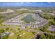 Panoramic aerial shot of a Primary-planned community surrounding a lake with fountain at 20472 Monza Loop, Land O Lakes, FL 34638