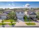 Aerial view of a neighborhood featuring well-manicured lawns, attractive homes, and a neatly paved street at 20472 Monza Loop, Land O Lakes, FL 34638