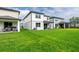 Well-maintained backyard with green grass and covered patios, offering a relaxing outdoor space at 20472 Monza Loop, Land O Lakes, FL 34638