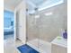 Modern bathroom featuring a glass-enclosed shower with tiled walls and a view into the bedroom at 20472 Monza Loop, Land O Lakes, FL 34638