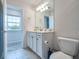Upstairs bathroom with white vanity and tile floor at 20472 Monza Loop, Land O Lakes, FL 34638