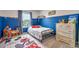 bedroom with blue walls, themed rug, and natural light from the window at 20472 Monza Loop, Land O Lakes, FL 34638