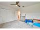 Bedroom featuring carpet, ceiling fan, closet, and natural light at 20472 Monza Loop, Land O Lakes, FL 34638