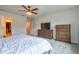 Bedroom with a large bed, soft carpet, and dressers for ample storage, along with a wall mounted TV at 20472 Monza Loop, Land O Lakes, FL 34638