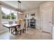 Elegant dining room with a wooden table, upholstered chairs, and a modern light fixture at 20472 Monza Loop, Land O Lakes, FL 34638