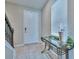 Inviting entryway featuring a staircase, window, and console table with decorative vases at 20472 Monza Loop, Land O Lakes, FL 34638