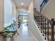 Hallway view showing decorative table, window and staircase with decorative metal spindles at 20472 Monza Loop, Land O Lakes, FL 34638